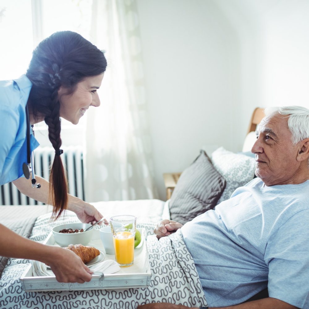 nurse-serving-breakfast-to-senior-man